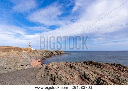 Seascape With A Quiet Sea Bay And A Lighthouse (faro De Favaritx) On The Island Of Menorca, Balearic