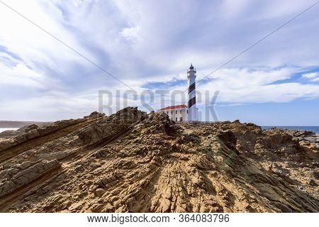 Beautiful View Of Famous Lighthouse Faro De Favaritx  Under The Sky With Clouds On The Island Of Men