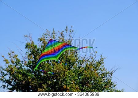 Children\'s Toy. Children Fly A Flying Kite.\nbackground Image For Web Design.