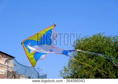 Children\'s Toy. Children Fly A Flying Kite.\nbackground Image For Web Design.
