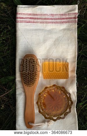 Honey Soap Lies On A Light Cotton Towel. Nearby Lies A Body Brush And Natural Honey. Set Of Accessor