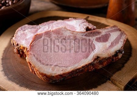 Delicious Smoked Pork Chops On A Rustic Wood Cutting Board.