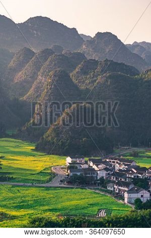 Rapeseed Flower Field And Villages At Wanfenglin  National Geological Park (forest Of Ten Thousands