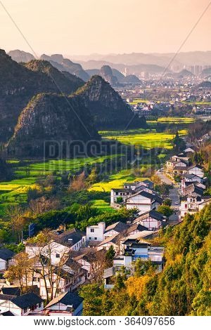 Rapeseed Flower Field And Villages At Wanfenglin  National Geological Park (forest Of Ten Thousands