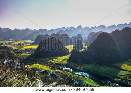 Rapeseed Flower Field And Villages At Wanfenglin  National Geological Park (forest Of Ten Thousands
