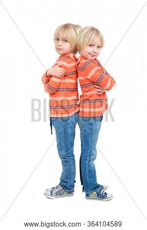 Two caucasian boys twins brothers posing in studio isolated on white