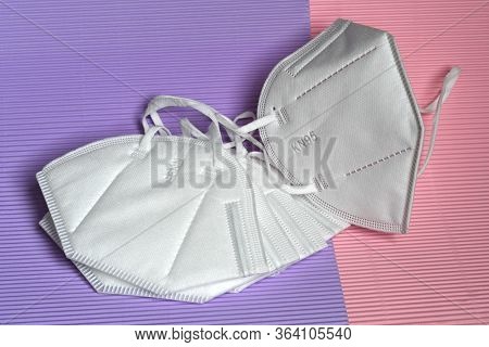 Closeup Of Antivirus Protection Masks Ffp2 Or Kn95 On Colored Background. Prevention For Coronavirus