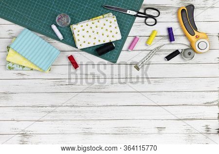 Quilting, Embroidery And Sewing Tools On The White Wooden Background. Patchwork Knife, Scissors, Lin