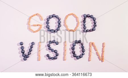 Vitamins And Supplements For Healthy Eyes On Pink Background. How To Maintain Good Vision Concept. B