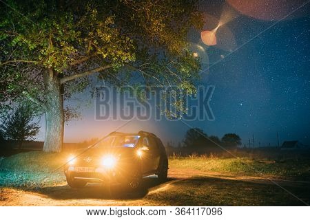 Gomel, Belarus - May 1, 2019: Night Starry Sky Above Car Renault Duster. Suv Parked Near Lonely Tree