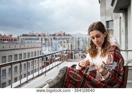 Young Caucasian Hipster/hippie Woman In Casual Clothes Playing Hawaiian Guitar, Sings A Song On A Uk