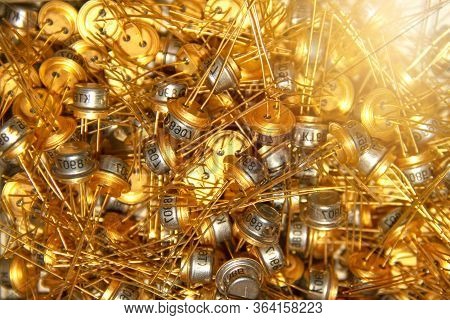 Radio Components - Transistors. A Scattering Of Many Radio Parts With Gilded Legs.