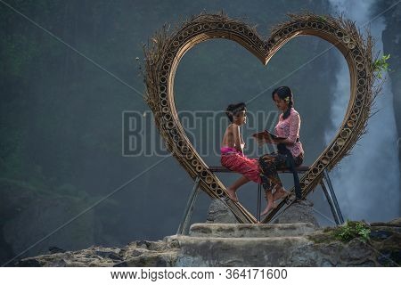 Blangsinga Waterfall, Blahbatuh, Gianyar, Bali, Indonesia - June 29, 2019 : Older Sister With Her Yo
