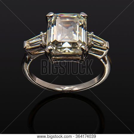 Jewelry, Golden Ring With A Diamond On A Black Background, Reflection From A Shiny Surface.