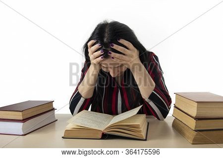 The Young Woman Covered Herself With A Thick Book. On The Table Are A Bunch Of Thick Book. Learns Th