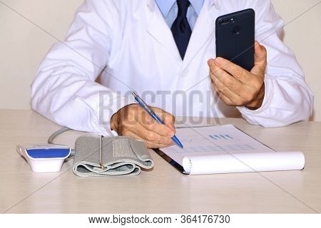 Close-up - A Doctor In A White Coat Measures A Patient's Blood Pressure