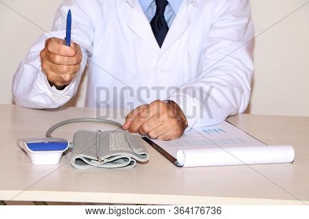 Close-up - The Doctor Sits At The Table And Writes The History Of The Patient's Pain