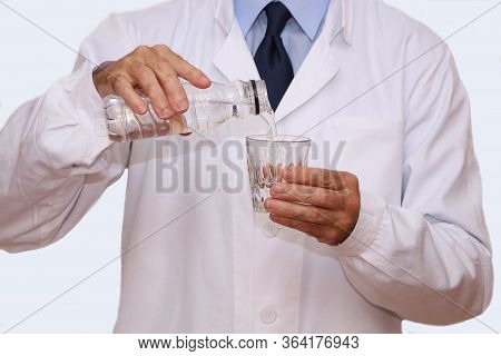 The Doctor Pours A Glass Of Useful Mineral Water For Diet