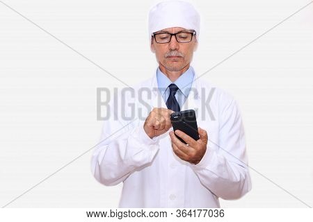 Close-up - A Doctor In A White Coat On The Phone Calls For Help