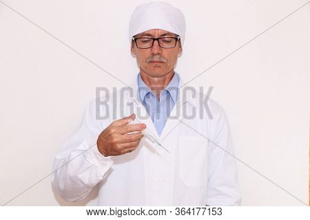 Concept - Doctor Holds A Syringe For Vaccination.
