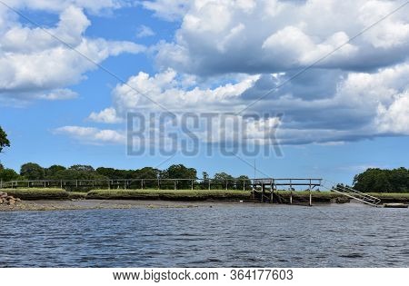 Beautiful Long Dock Over Marsh On A Tidal River.