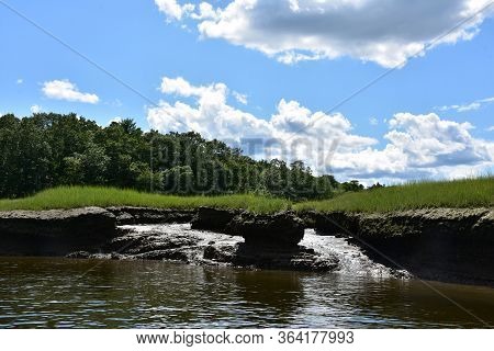 Pretty Marsh Land And Tidal Flats Under Cloudy Skies.