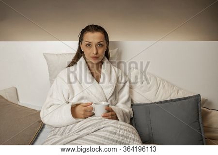 Beautiful Calm Girl With Wet Hair After Shower Relaxing At Home Sitting In Bed Drinking Herbal Tea I