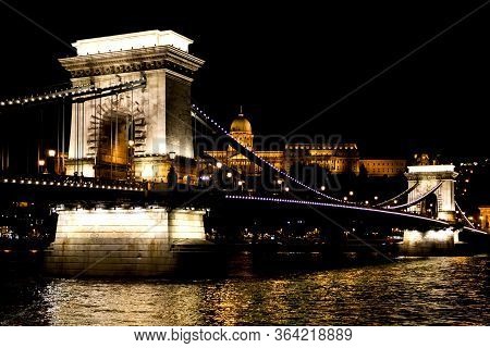 Amazing Night View Of The Illuminated Chain Bridge Close-up. Beautiful Vintage Lantern. Budapest
