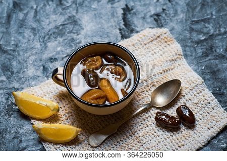 Homemade Compote With Dried Fruit Mix Of Dates And Figs With Lemon In A Cup