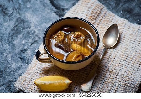 Homemade Compote With Dried Fruit Mix Of Dates And Figs With Lemon In A Cup