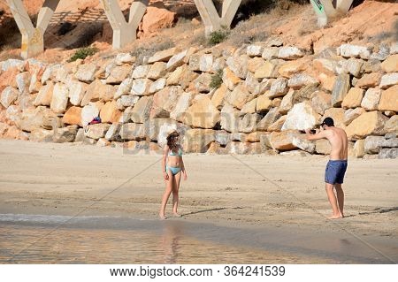 Orihuela, Costa Blanca, Spain - September 20, 2018:people Relax On The Sandy Beach Of Playa De Aguam
