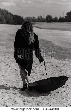 Woman In The Coat Standing With Open Umbrella