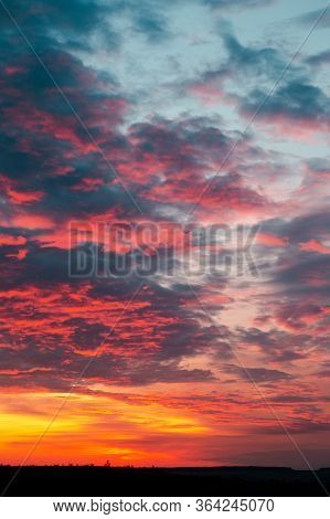 End Of Day Concept. Beautiful Fiery Orange Sunset Sky With Horizon