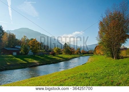 Sunny Autumn Day By The River In Bavarian Alps