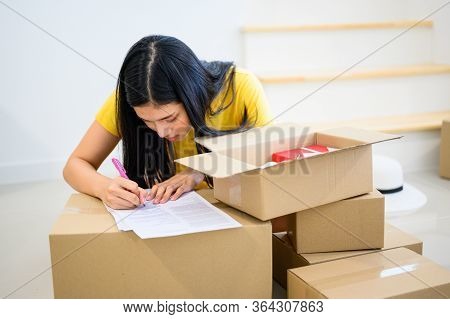 Thai Entrepreneur Couple Are Packing. Oline Shopping And Home Delivery. Lock Down And Self-quarantin