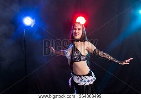 Girl Dancing Belly Dance, Fusion Or Tribal. A Woman In A Beautiful Costume Demonstrates Charming And