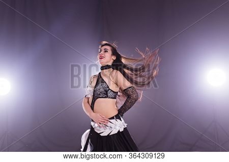 Girl Dancing Belly Dance, Fusion Or Tribal. A Woman In A Beautiful Costume Demonstrates Charming And