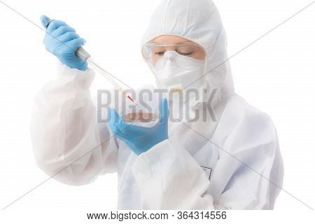 Female Laboratory Worker Wearing Protective Hazmat Biosecurity Suit, Gloves, Respirator Mask And Gog