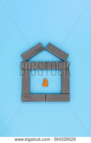 The Concept Of Quarantine And Self-isolation, A Lonely Wooden Rabbit Sits Alone In A House
