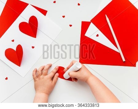 Kid Makes Mothers Day Or Valentines Day Greeting Card. Diy Holiday Card With Red Paper Volumetric He