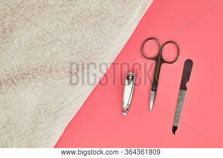 Manicure Tools With White Towel On Pink Background