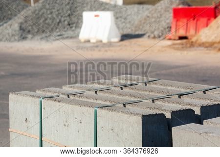 Piled Concrete Curbstones. Construction Material For Road Construction Works. Construction Backgroun