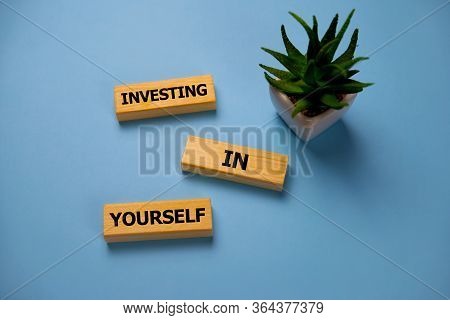 Investing In Yourself - Increase Concept. Inscription On Blue Brick Wall. Investing In Yourself - On