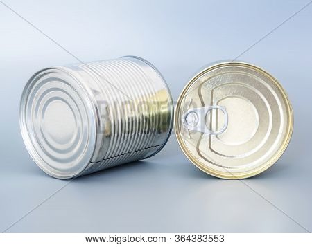 Many Tin Cans Of Gold And Silver Color, Isolated On A Gray Background, Top View, Copispace, Mockup. 