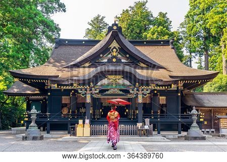 Woman Wearing Japanese Traditional Kimono With Umbrella At Katori Shrine In Chiba, Japan.