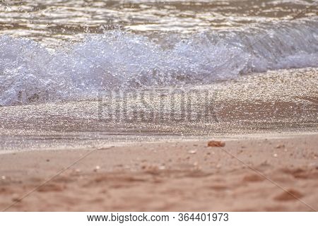 Detail Of Sand And Waves On Empty Beach. Uncrowded Travel Concept. Algarve, Portugal.
