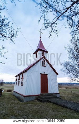 Typical Red Colored Wooden Church In Fludir Town In South Iceland Within The Golden Circle. Sunset L