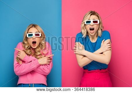 Scared Blonde Sisters In 3d Glasses Looking At Camera On Blue And Pink Background