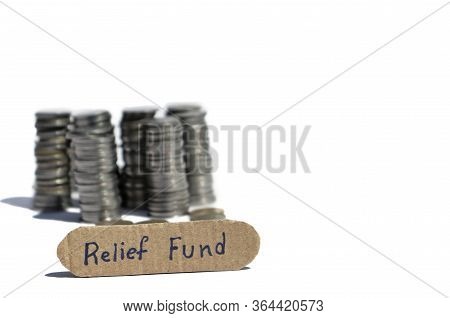 Relief Fund Tag With Stack Of Blurred Coins Money Isolated On White Background With Copy Space