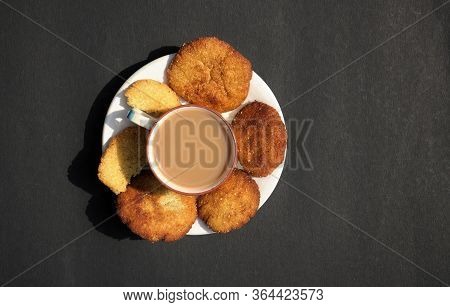 Top View Of Tea Cup And Homemade Semolina Cookies In A Plate Isolated On Black Background With Copy 